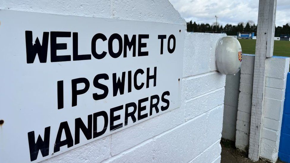 Sign alongside the stand reading 'Welcome to Ipswich Wanderers'