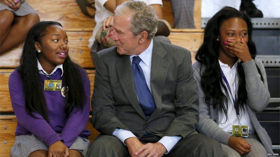 Former US President George W. Bush talks with schoolchildren at Warren Easton Charter High School one day before the ten year anniversary of Hurricane Katrina in New Orleans, Louisiana, 28 August 2015.