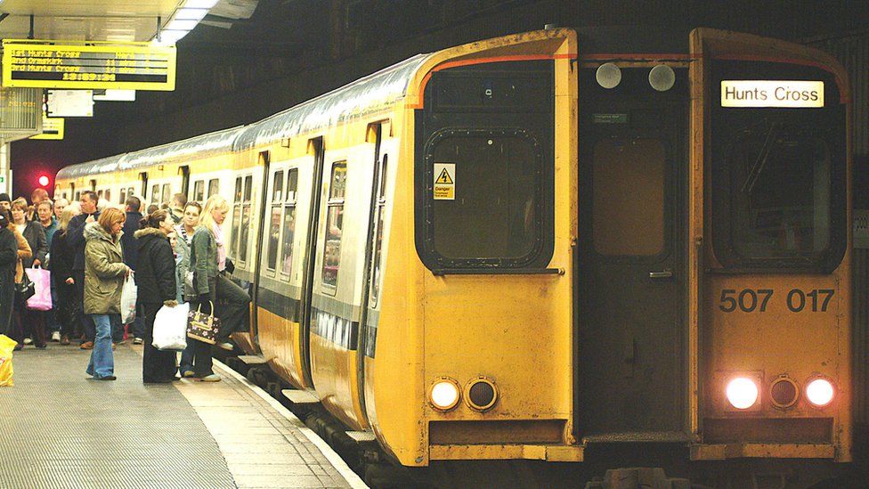 passengers board Merseyrail train