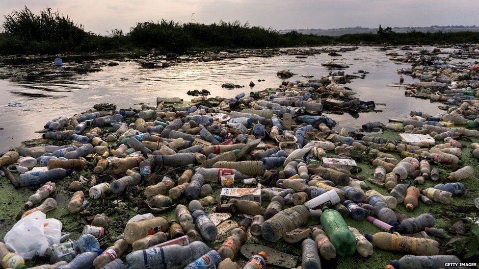 plastic bottles polluting a river