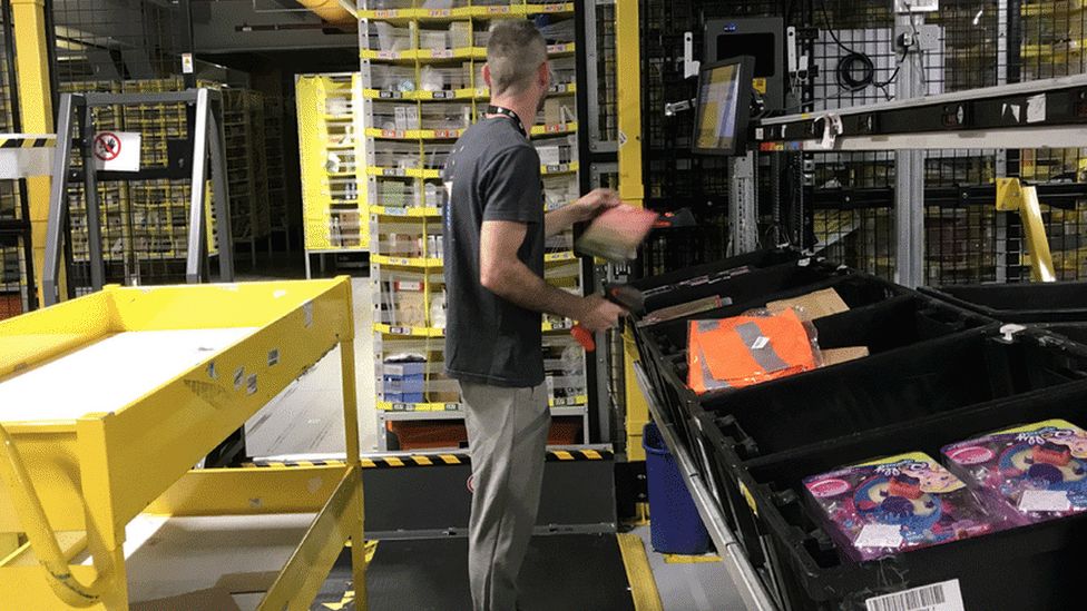 A person sorting goods at Amazon warehouse