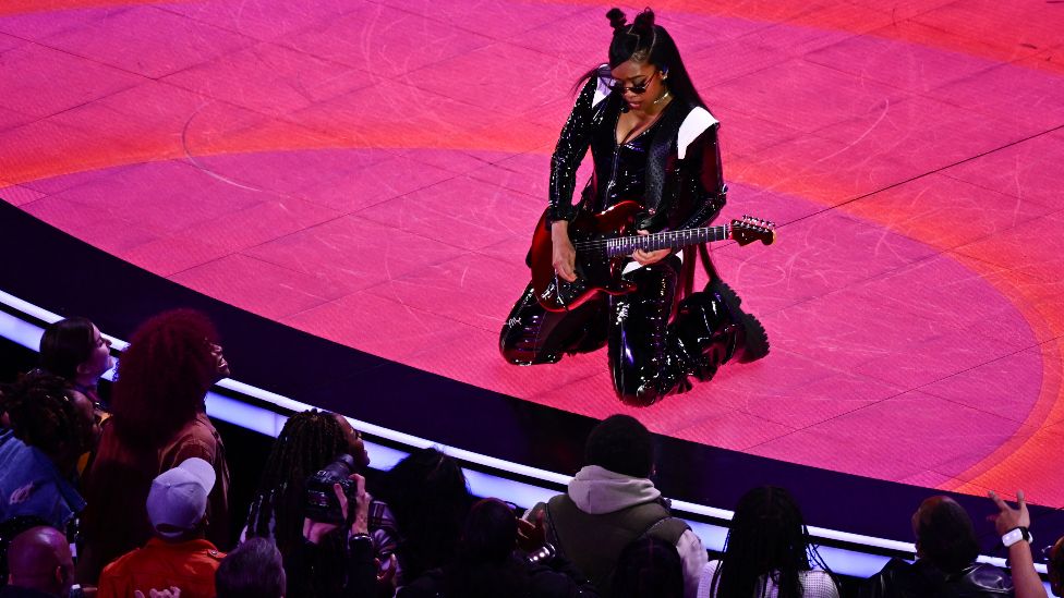 US singer H.E.R. performs during Apple Music halftime show of Super Bowl LVIII between the Kansas City Chiefs and the San Francisco 49ers at Allegiant Stadium in Las Vegas, Nevada, February 11, 2024