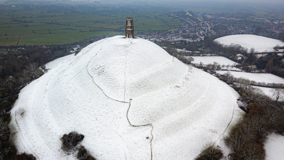 Snow settles on Glastonbury Tor in Somerset