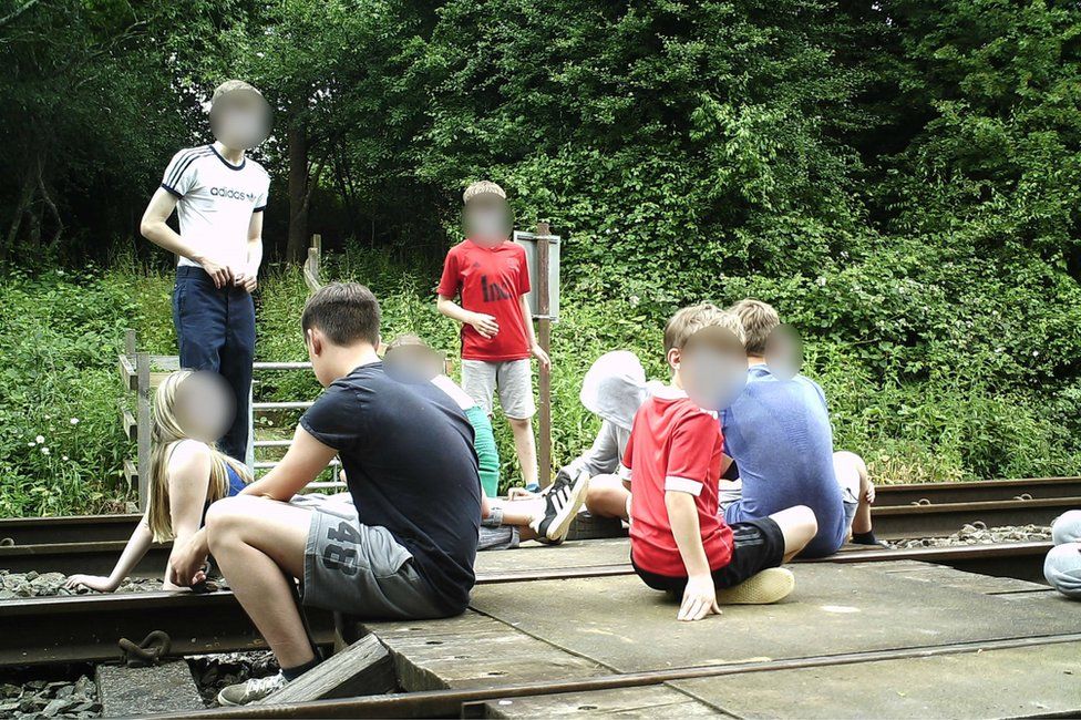 Children on level crossing in Wing
