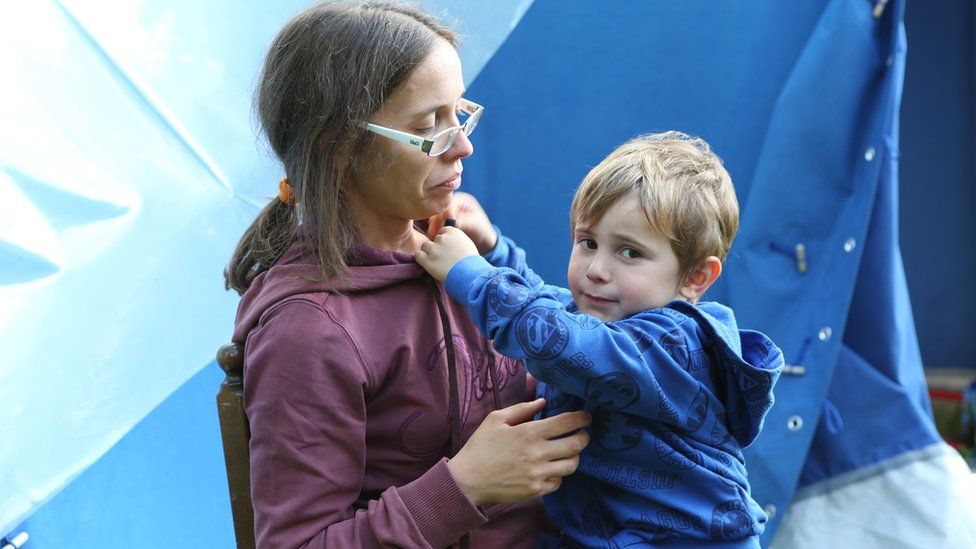 Roberta Pompa with her son Samuele outside the tent in their garden in Piedilama, Marche, Italy, 26 September 2016