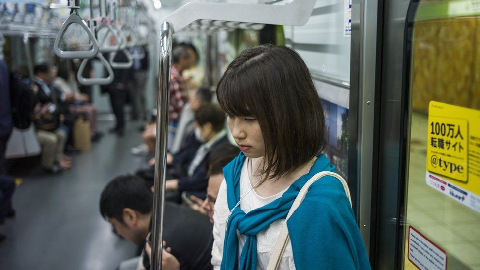 Woman on an underground train in Tokyo