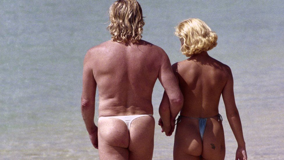 Peter Stringfellow with his girlfriend Helen Benoist on a beach in Barbados, circa 1990.