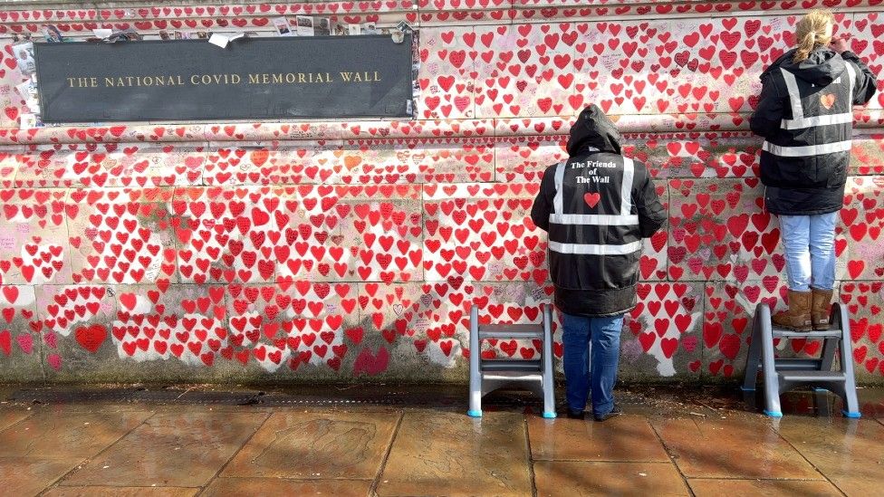 Volunteers continue to fix fading hearts on the wall