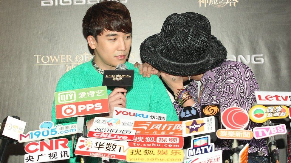 Seungri and G-Dragon of South Korean boy band Bigbang give a press conference in 2014