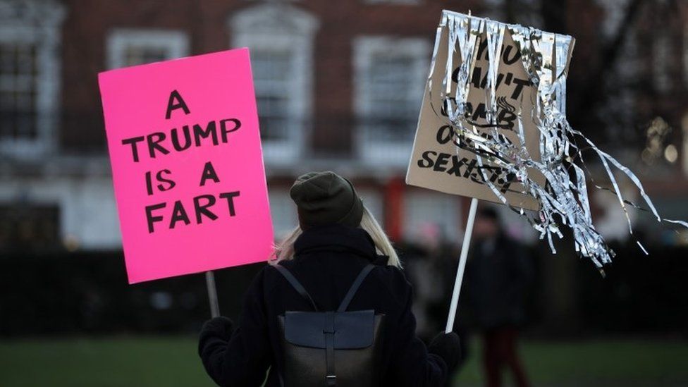 A London protester holding a sign saying 'A Trump is a fart' - 21 January 2017