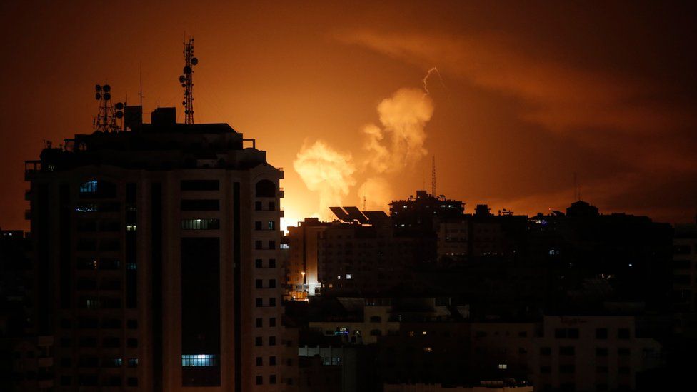 Smoke rises above buildings in Gaza City as Israel launches air strikes late on 6 April 2023