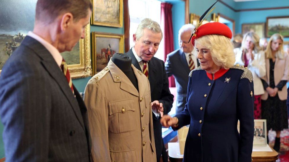 Queen Camilla views the tunic