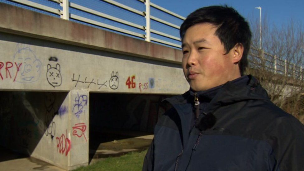 Jason Fong, standing near a bridge