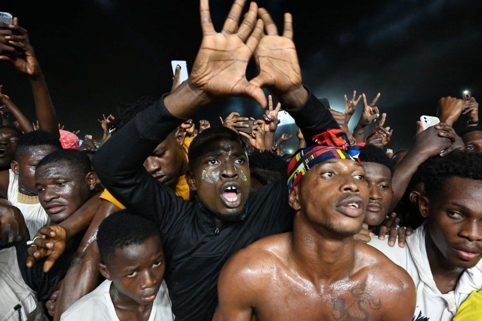 Spectators cheer as they attend the 15th Festival of Urban Music of Anoumabo in Abidjan - Sunday 30 April 2023