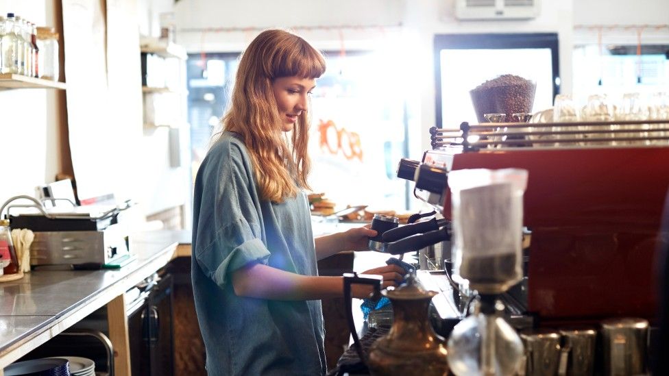 Woman working a coffee machine