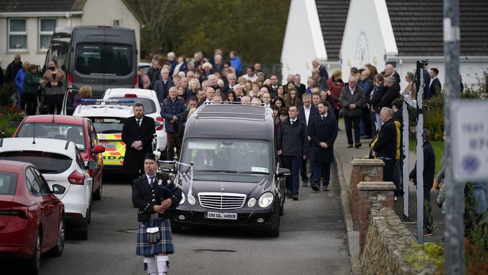 A piper plays as the hearse carrying Martin McGill, 49, arrives at St Michael's Church, Creeslough, for his funeral mass. Martin died following an explosion at Applegreen service station in the village of Creeslough in Co Donegal on Friday