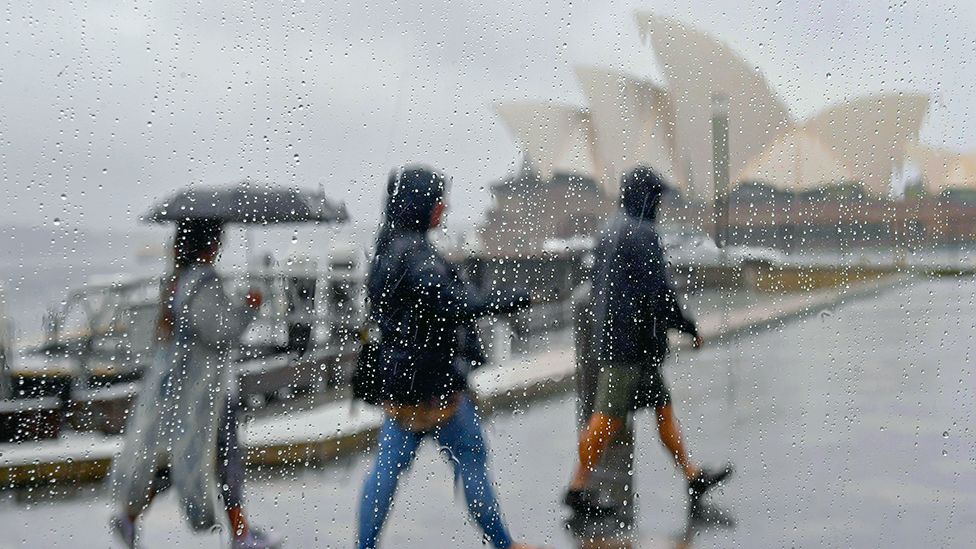 People walk in the rain in Sydney