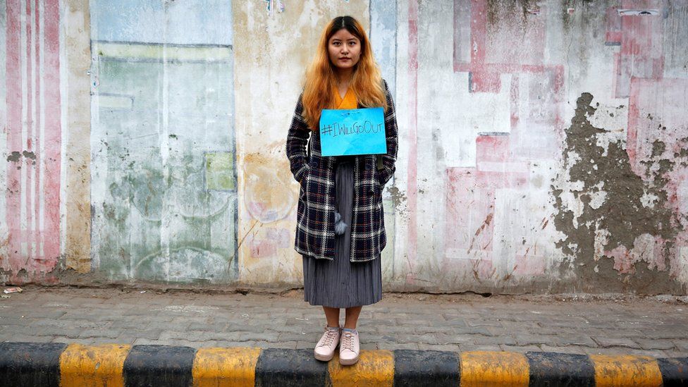 A woman waits for the start of the #IWillGoOut rally, organized to show solidarity with the Women"s March in Washington, along a street in New Delhi, India January 21, 2017