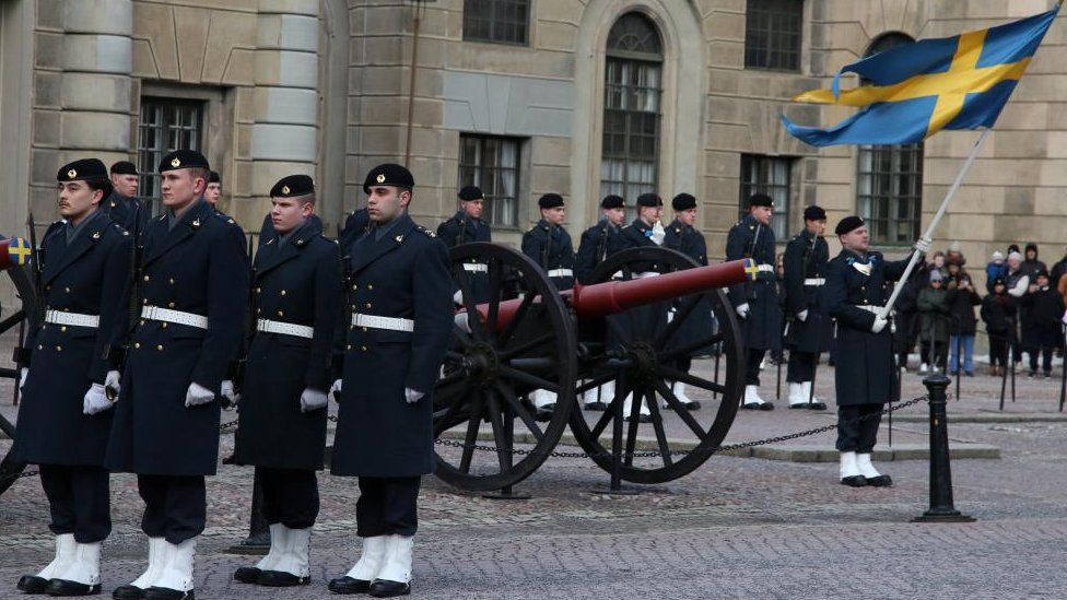 Swedish soldiers take part in the changing of the guard ceremony in the courtyard of the Royal Palace in Stockholm, 25 February 2024