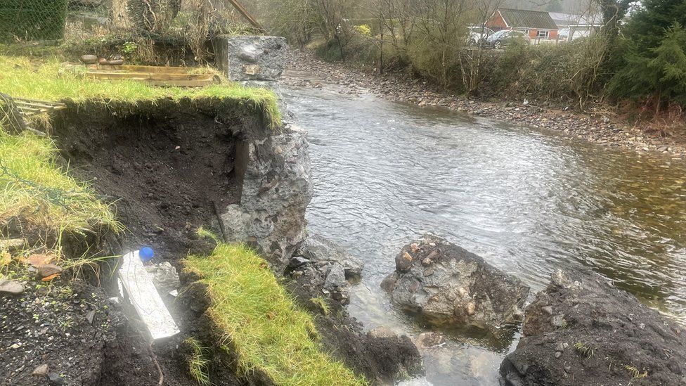 An entire section of the wall has collapsed into the River Tawe