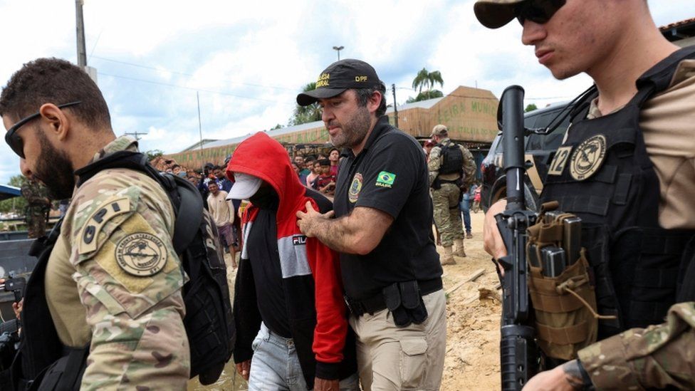 Federal police officers in Brazil escorted a man accused of being involved in the disappearance of Dom Phillips and Bruno Pereira. 15 June 2022.