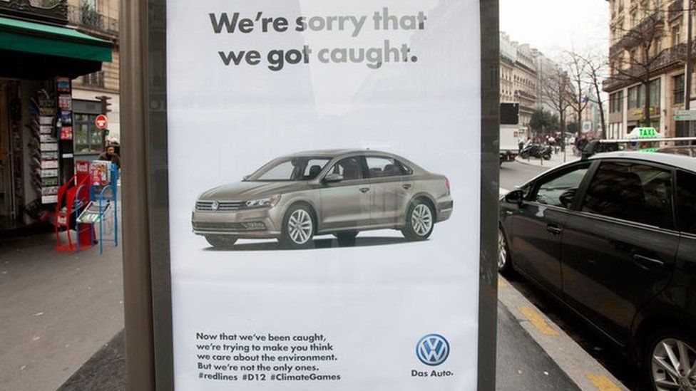 A poster parodying Volkswagen reads: "We're sorry that we got caught."