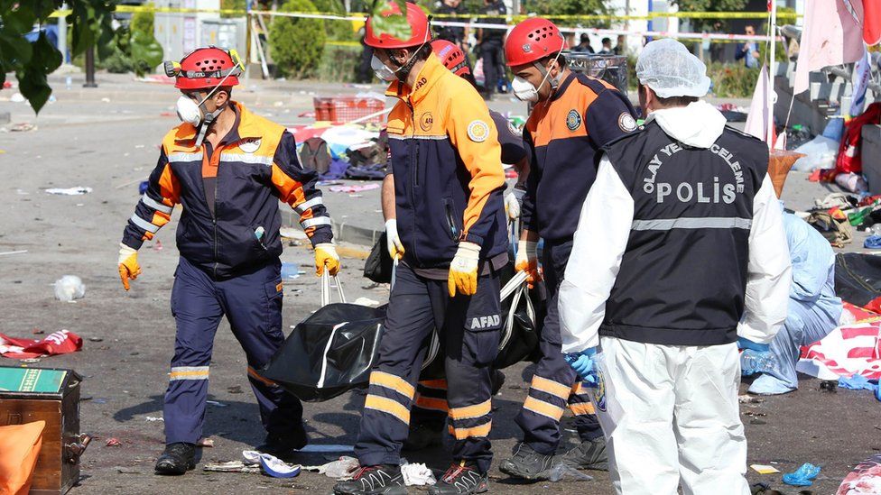 Rescue workers taking away bodies in Ankara, Turkey, Saturday 10 October 2015