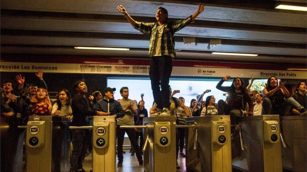 Students demonstrate at Los Heroes metro station during a mass fare-dodging protest in Santiago, Chile, on October 18, 2019