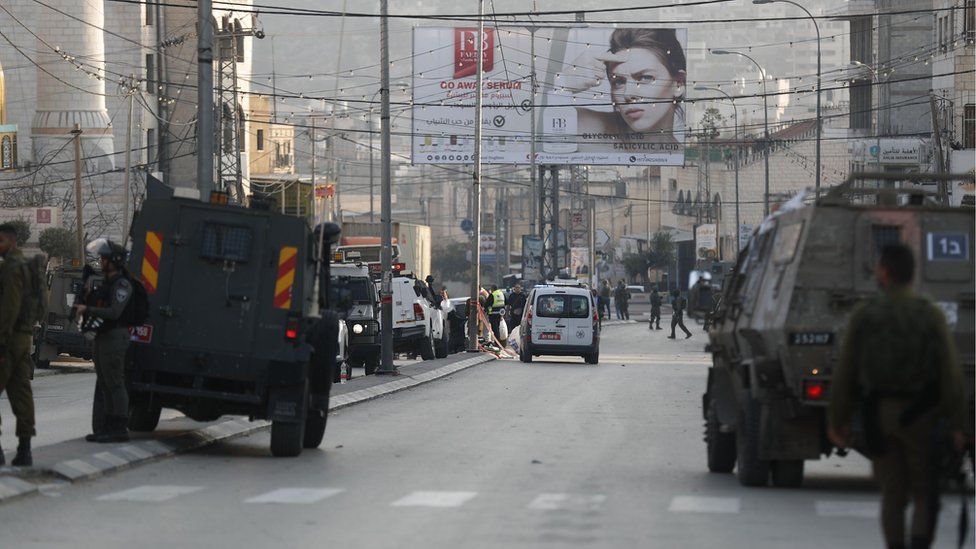 Israeli forces are deployed at the scene of an attack that killed two Israeli settlers in Hawara, in the occupied West Bank, (26 February 2023)