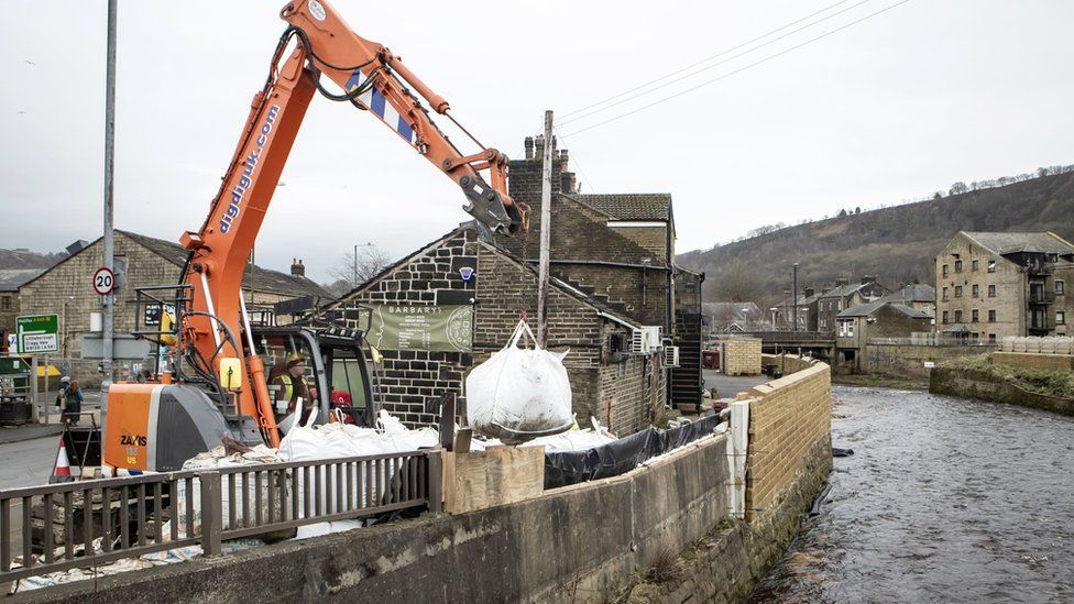 Workers construct flood defences in Mytholmroyd ahead of Storm Dennis