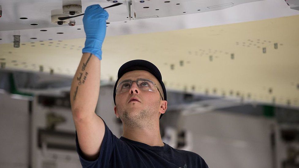 An Airbus employee constructs a wing for an Airbus A350 aircraft at Airbus' wing production plant near Broughton in north-east Wales