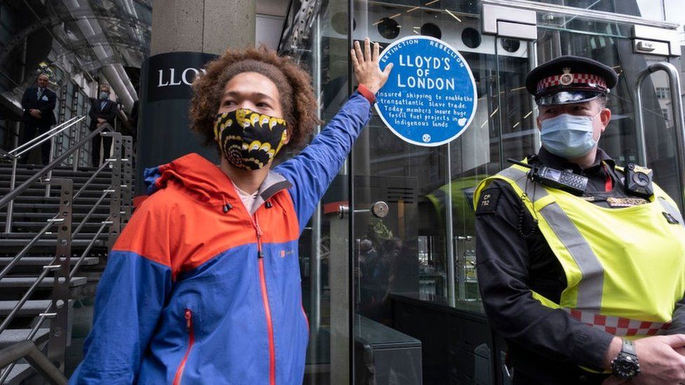 Protestor outside Lloyd's of London building.