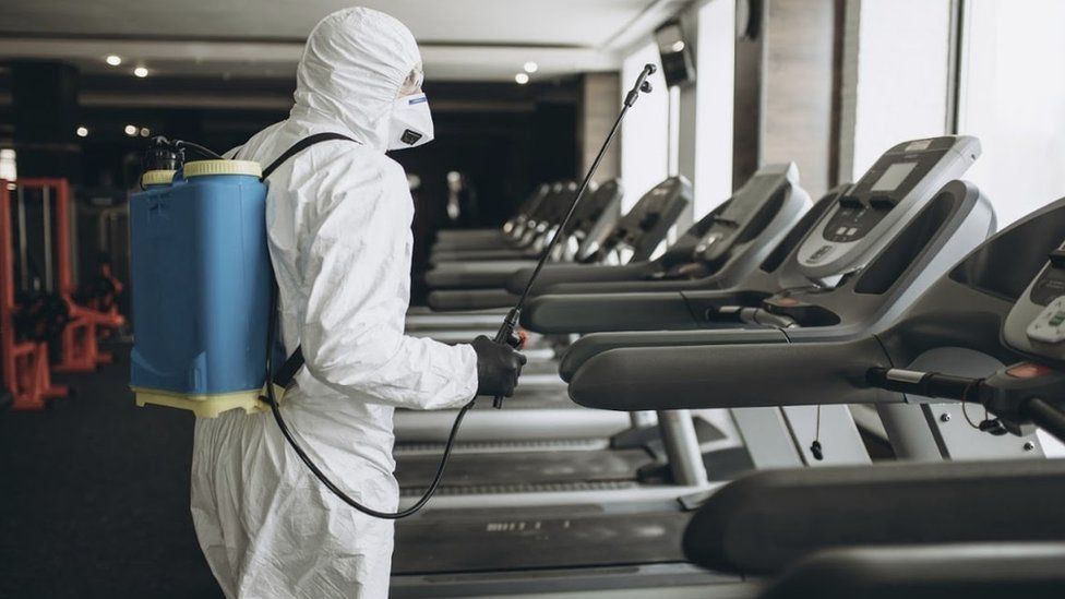 PSS worker decontaminating gym