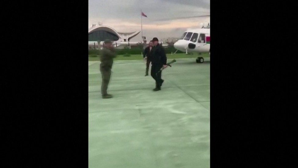 Lukashenko carries assault rifle as he gets off helicopter