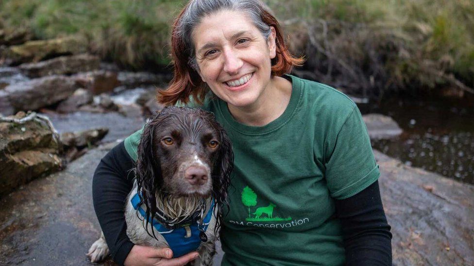 Rachel Cripps, a conservation detection dog handler, with Reid the dog