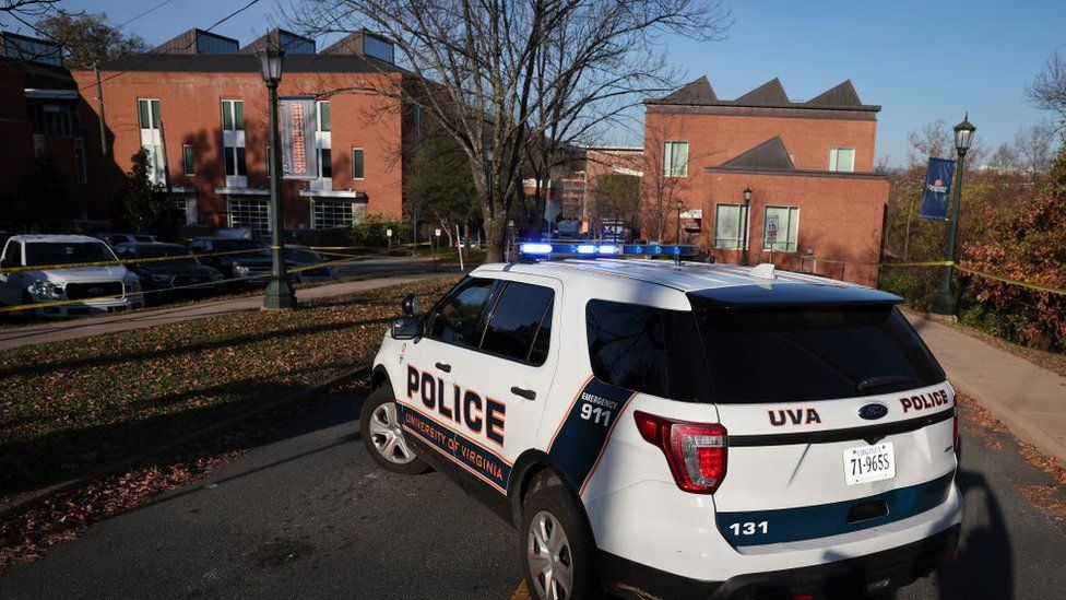 A law enforcement car blocks access to the crime scene where 3 people were killed and 2 others wounded on the grounds of the University of Virginia on November 14, 2022 in Charlottesville, Virginia.
