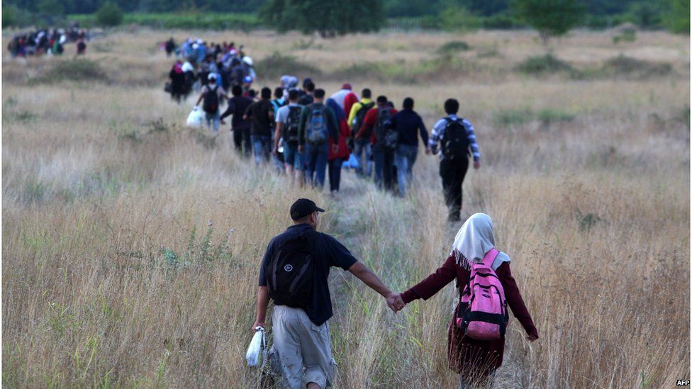 Migrants walk across border from Greece to Macedonia, 23 August 2015