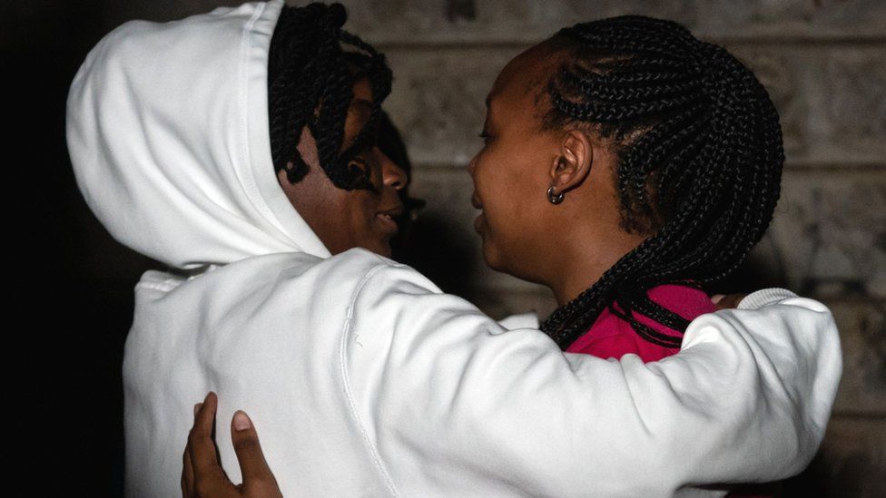 People react as they are reunited with family after being evacuated from the DusitD2 compound in Nairobi, Kenya