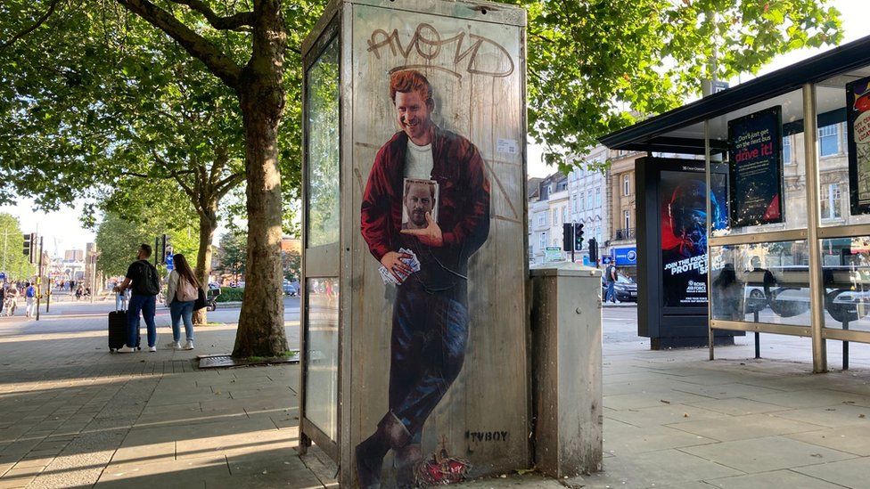 Graffiti portrait of Prince Harry on a phone box