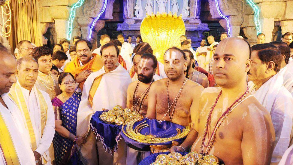 This handout picture released by the Public Relation Department of the Government of Telangana and taken on February 22, 2017, Telangana Chief Minister K Chandrashekhar Rao (centre L) with family members and supporters carrying lavish offerings for a temple in Tirumala.