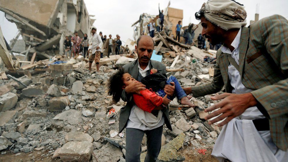 A man carries Buthaina Muhammad Mansour from the site a Saudi-led coalition air strike that killed members of her family in Sanaa, Yemen (25 August 2017)