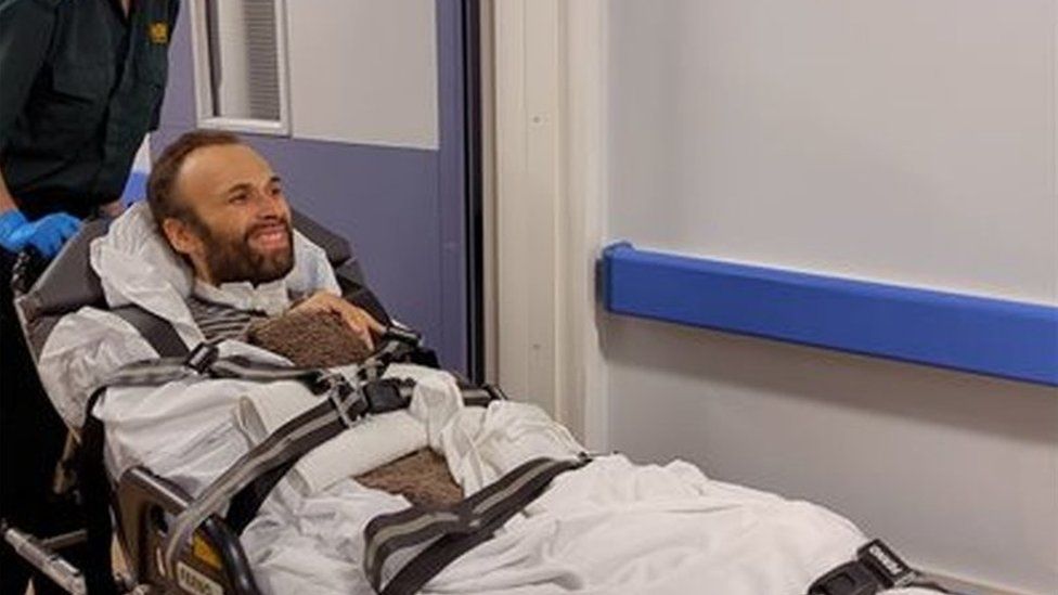 Pierre Rudd being transported on a hospital bed
