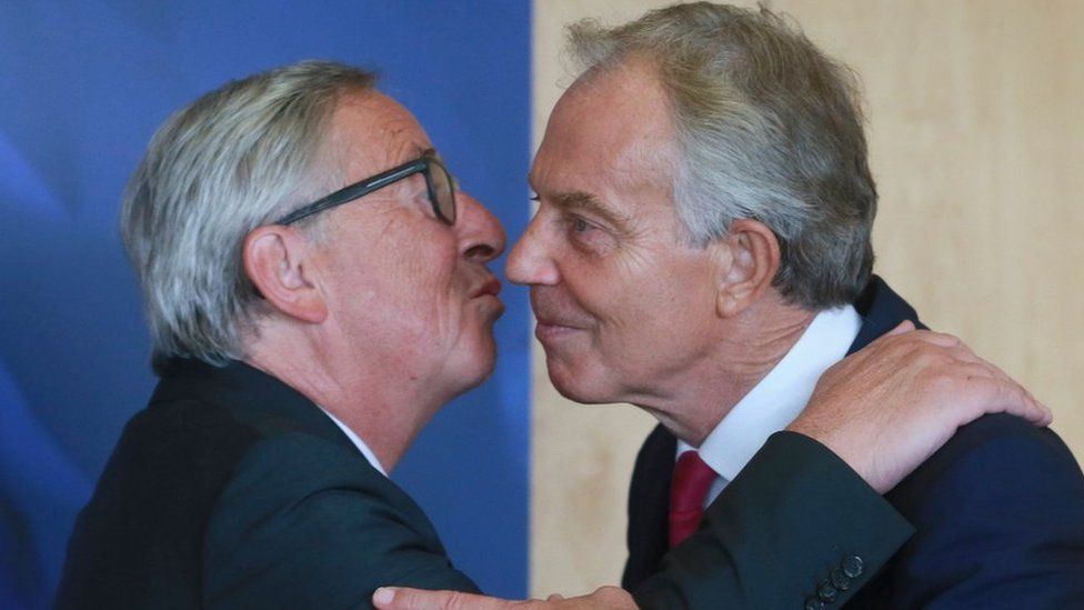 Jean-Claude Juncker greeting former PM Tony Blair with a kiss.