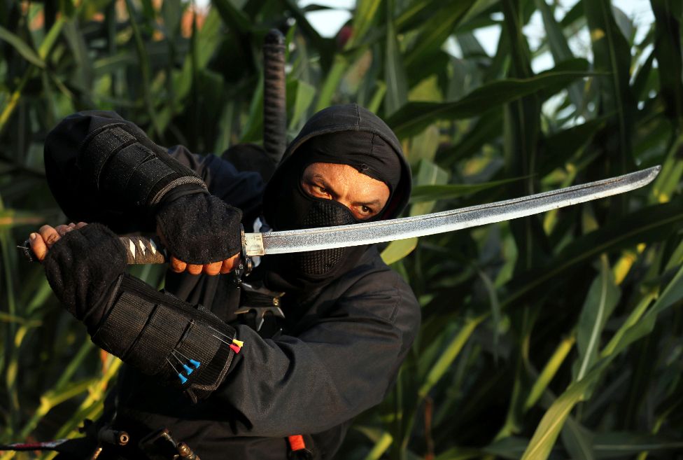 Abdel Qader Ahmed, a self-taught ninja enthusiast known as Abouda Ninja, holds a sword he made himself, at a field in the Sharqia Governorate, north of Cairo, Egypt August 13, 2021.