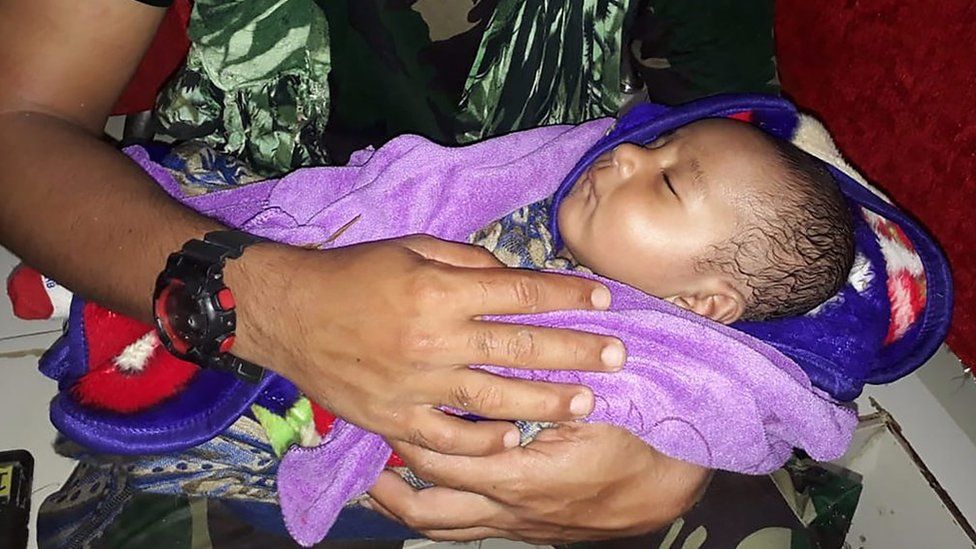 A five-month-old boy has been rescued in Indonesia's flash floods