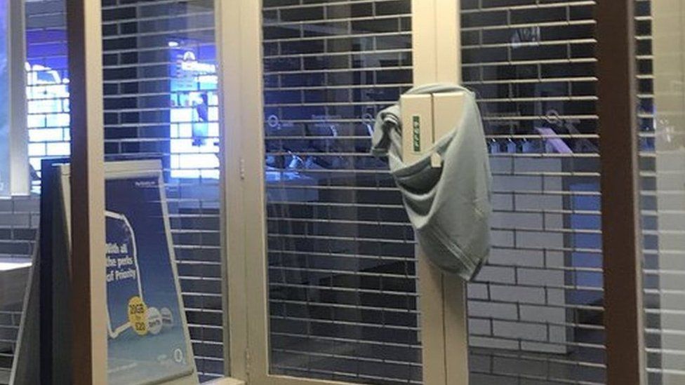 Sweater tied to shop doors