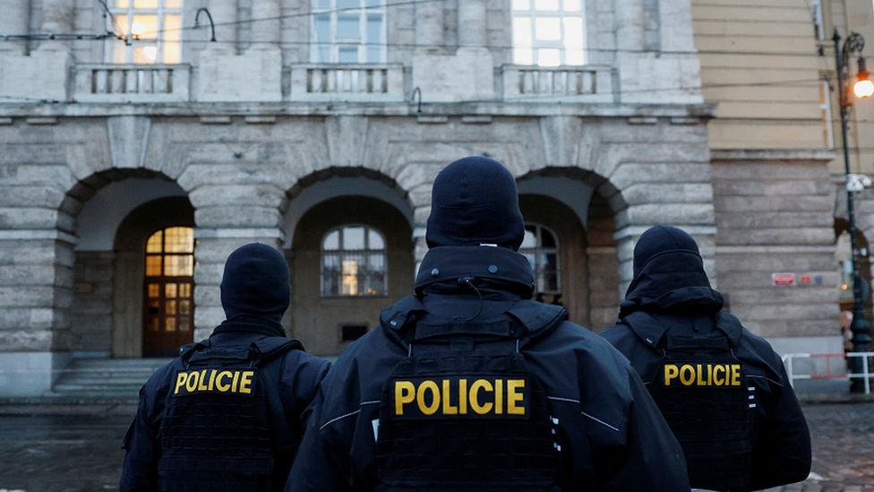 Members of the police stand guard following a shooting at one of Charles University's buildings in Prague, Czech Republic
