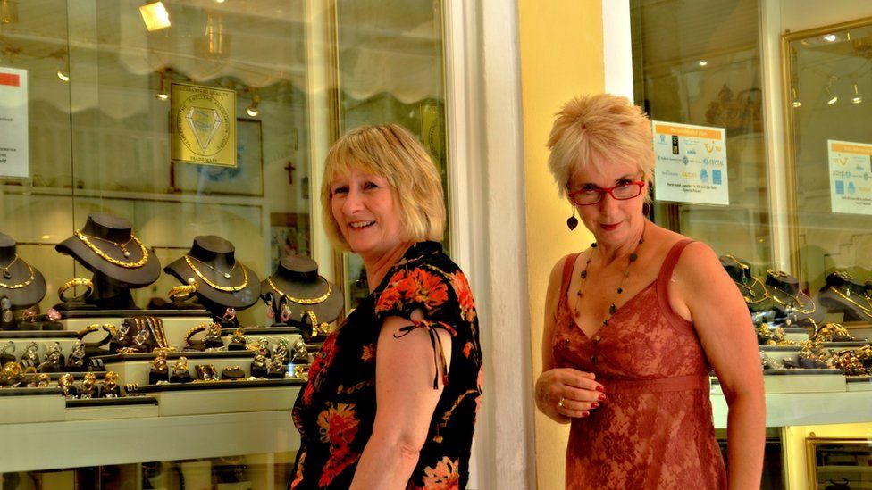 Women looking at jewellery in a shop window