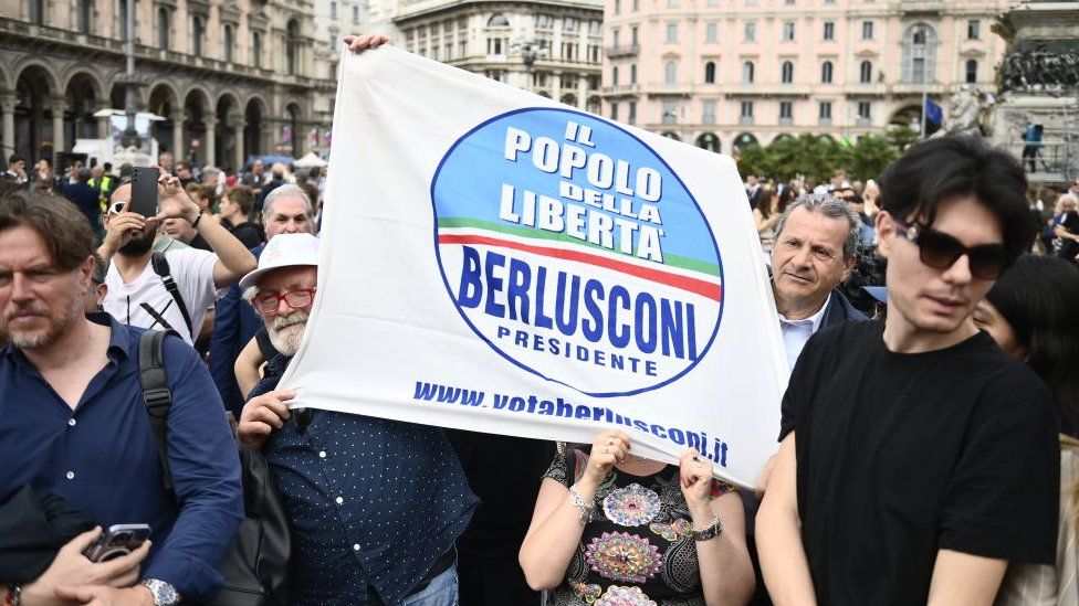 People holds a Forza Italia emblem  for the authorities   ceremonial   for Silvio Berlusconi connected  June 14, 2023 successful  Milan, Italy. S