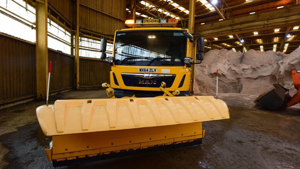 Stockpiled salt and salt spreader